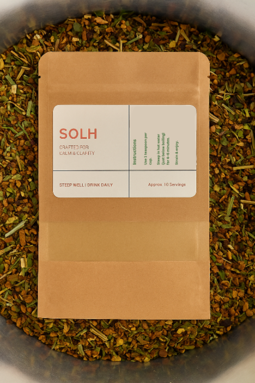 Tea packaging labeled 'SOLH' on a bed of loose tea leaves.